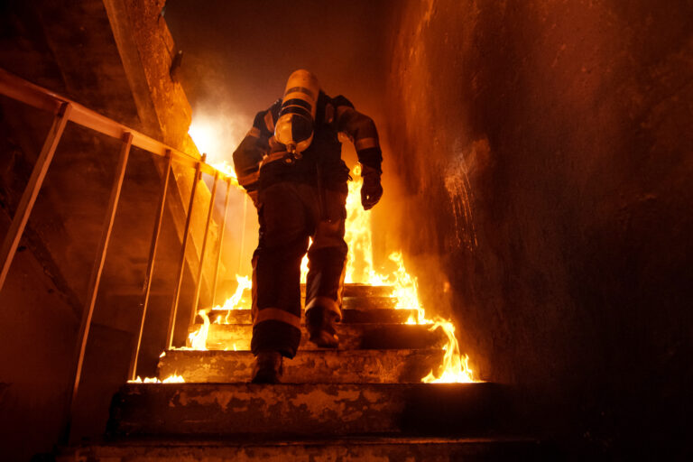 Strong,And,Brave,Firefighter,Going,Up,The,Stairs,In,Burning