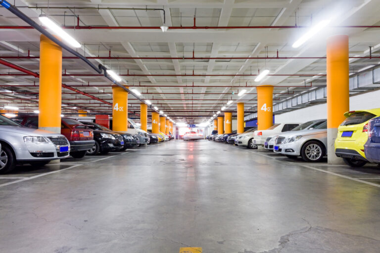 Parking,Garage,,Underground,Interior,With,A,Few,Parked,Cars