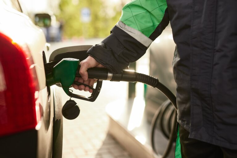 Crop,Anonymous,Male,Employee,In,Protective,Uniform,Pouring,Fuel,Into