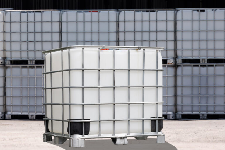 White,Ibc,Containers,With,The,Factory,Background.