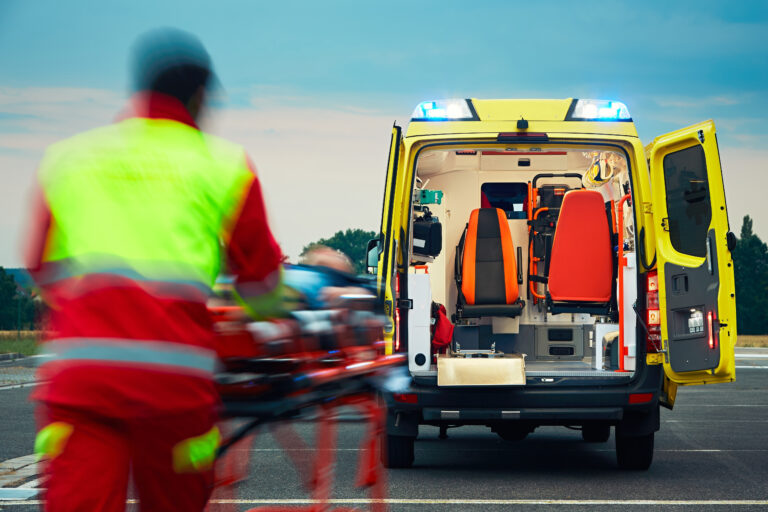 Emergency,Medical,Service.,Paramedic,Is,Pulling,Stretcher,With,Patient,To