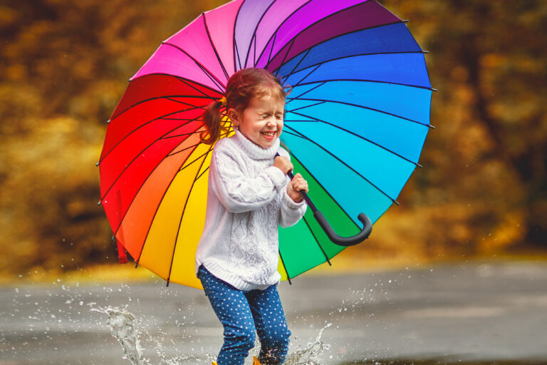 Happy,Funny,Ba,Child,By,Girl,With,A,Multicolored,Umbrella