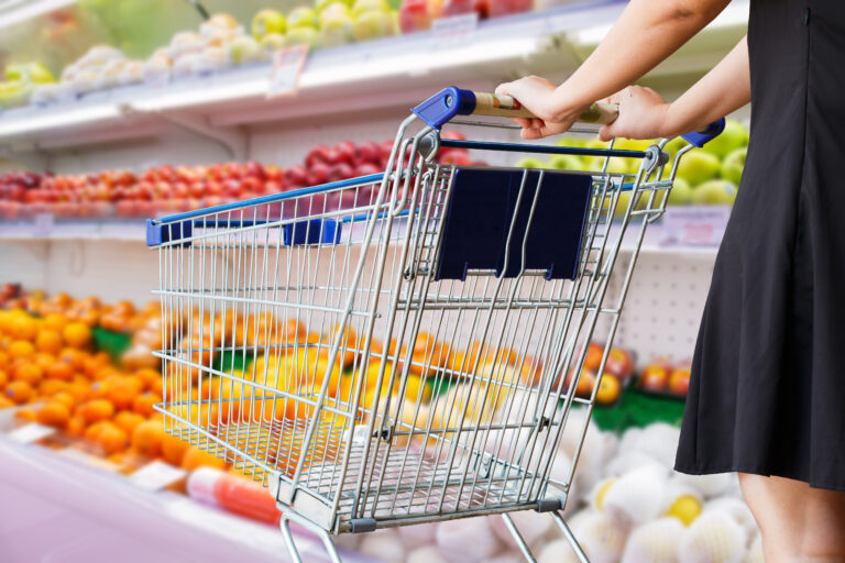 Woman,Pushing,Shopping,Cart,In,Grocery,Store