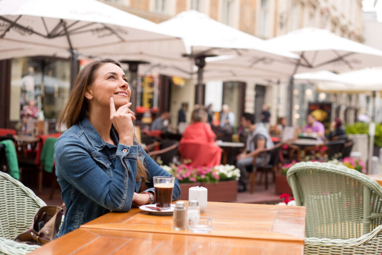 Young,Woman,Looking,Thoughtful,Outside,A,Restaurant