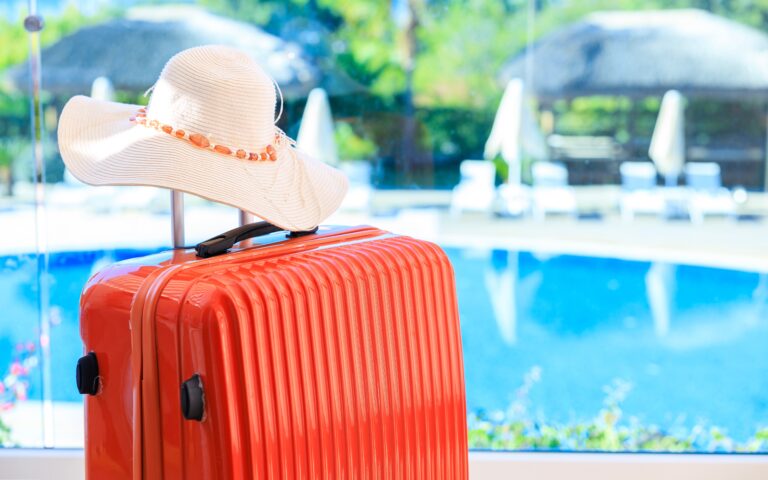 Suitcase,In,Hotel,Room,Against,Swimming,Pool,Landscape.,Suitcase,And