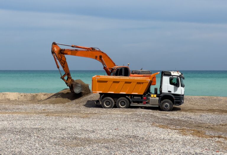 Beach,Renovation.,Excavator,Load,Stones,In,Dump,Truck,Near,Coastline