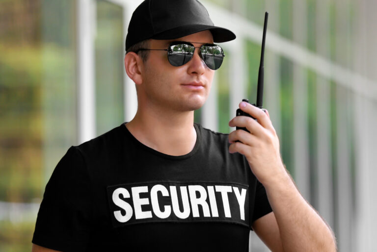 Male,Security,Guard,With,Portable,Radio,Outdoors