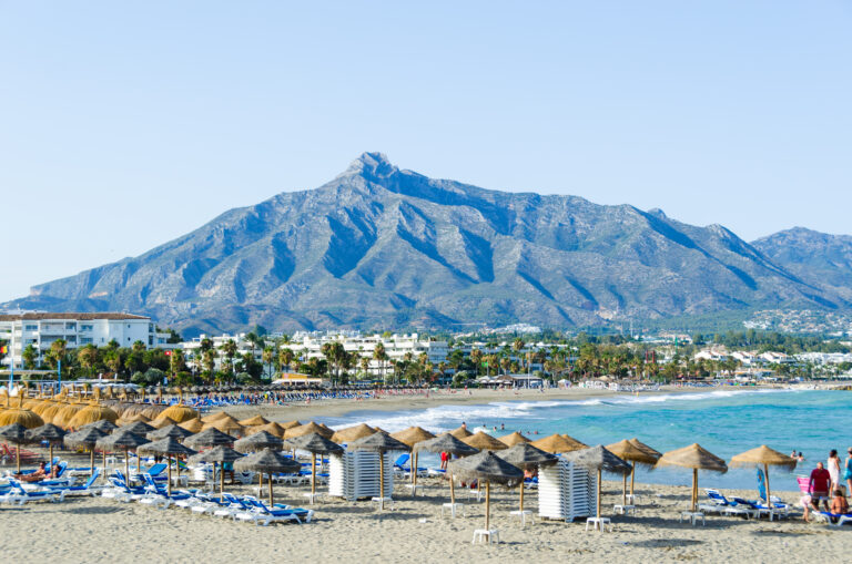 Holidaymakers,Relaxing,On,The,Beach,,Puerto,Banus,,Marbella,,Costa,Del