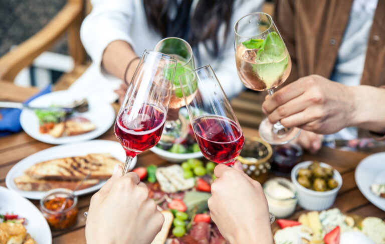 Hands,With,Glasses,Of,Wine,And,Tasty,Food