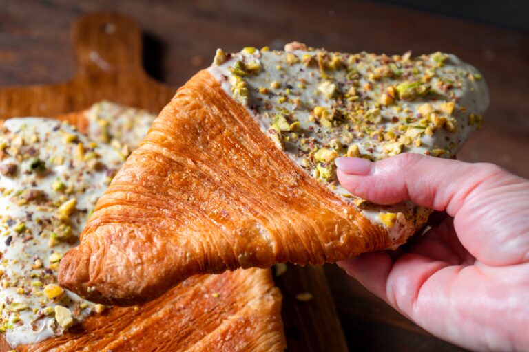 Flat,Croissant,,Trendy,Pastry,,Croissant,With,Pistachio,Glaze,And,Crushed