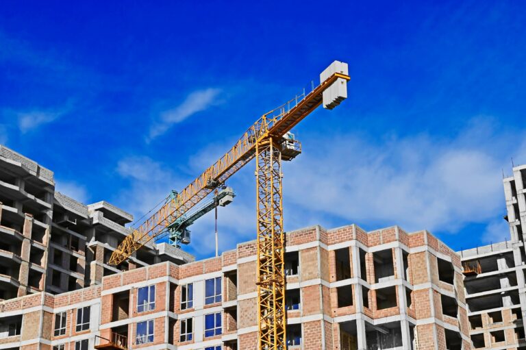 Construction,Site,With,Tower,Crane,And,Blue,Sky