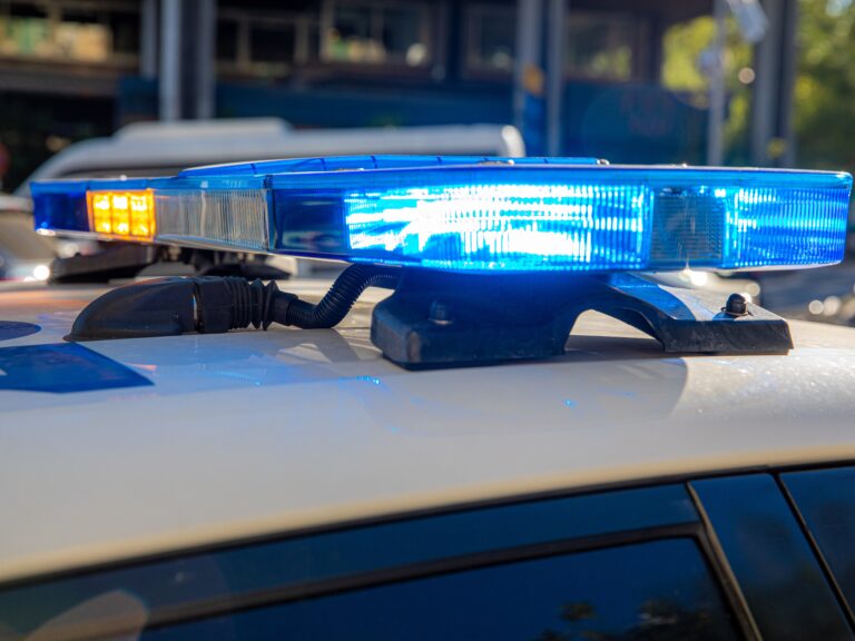 Blue,Lights,On,The,Roof,Of,A,Police,Car,With
