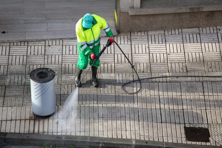 Sweeper,Cleaning,A,Street,Sidewalk,With,High,Pressure,Water,Jet
