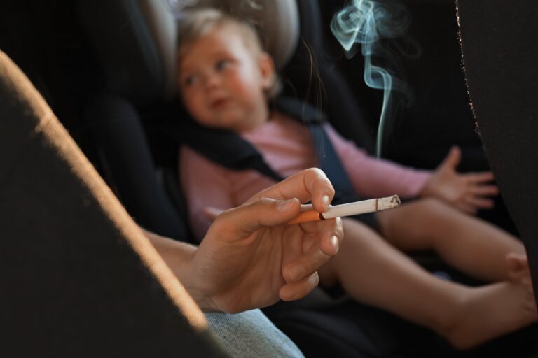 Mother,With,Cigarette,And,Child,In,Car,,Closeup.,Don't,Smoke