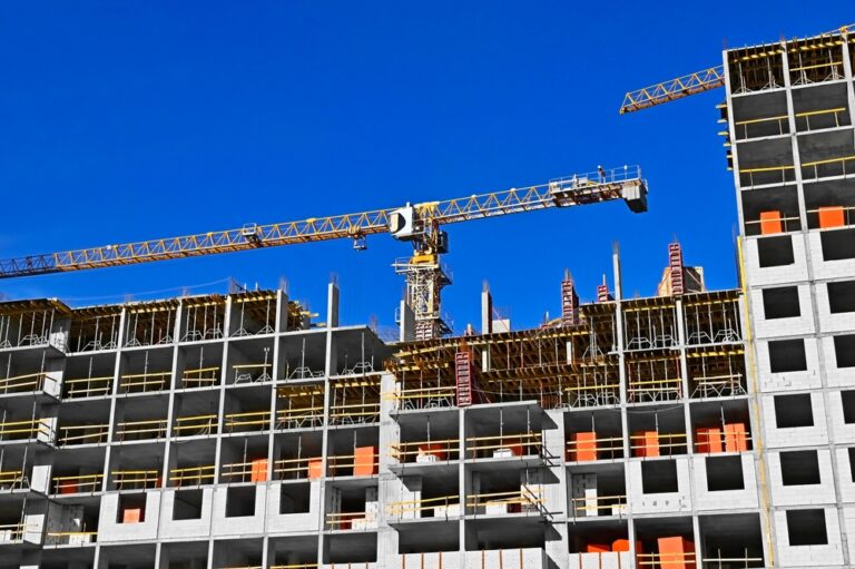 Multistory,Construction,Site,With,Crane,And,Blue,Sky