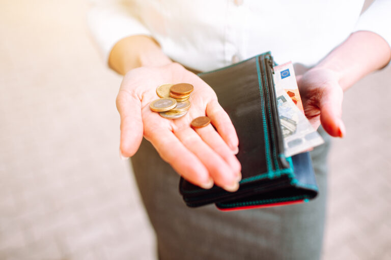 Coins,On,A,Woman,Hand,Wearing,Office,Suit.,Saving,Money,
