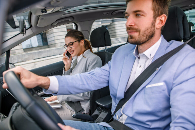 Young,Business,People,Working,Together,While,Traveling,By,A,Car.