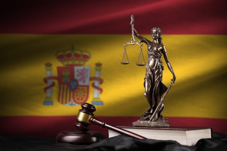 Spain,Flag,With,Statue,Of,Lady,Justice,,Constitution,And,Judge