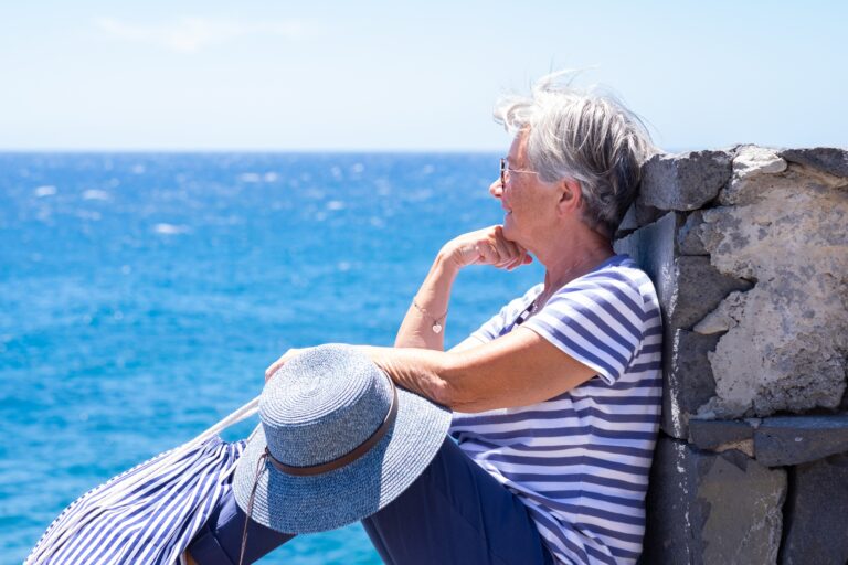 Smiling,Senior,Woman,In,Striped,T-shirt,Sitting,By,The,Sea