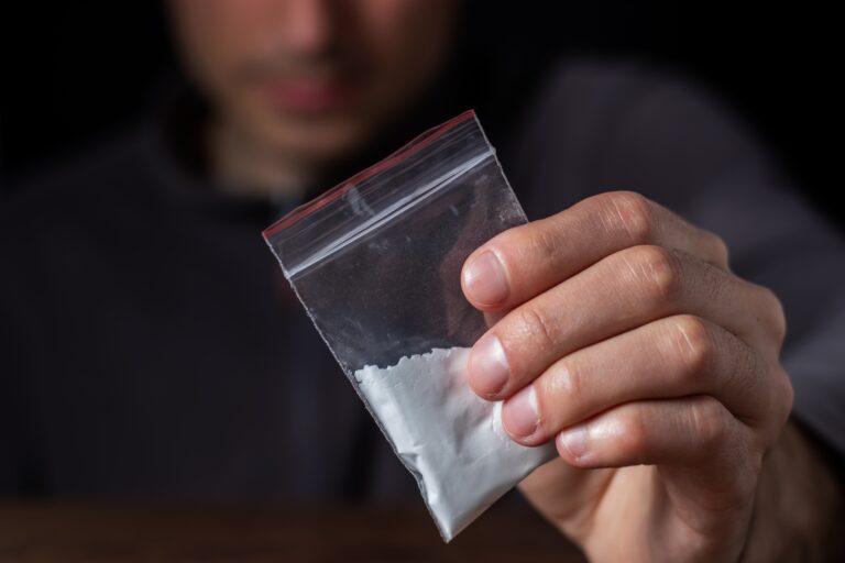 Concept,Drug,Addiction.,Man,Hand,Holds,Plastic,Packet,Or,Bag