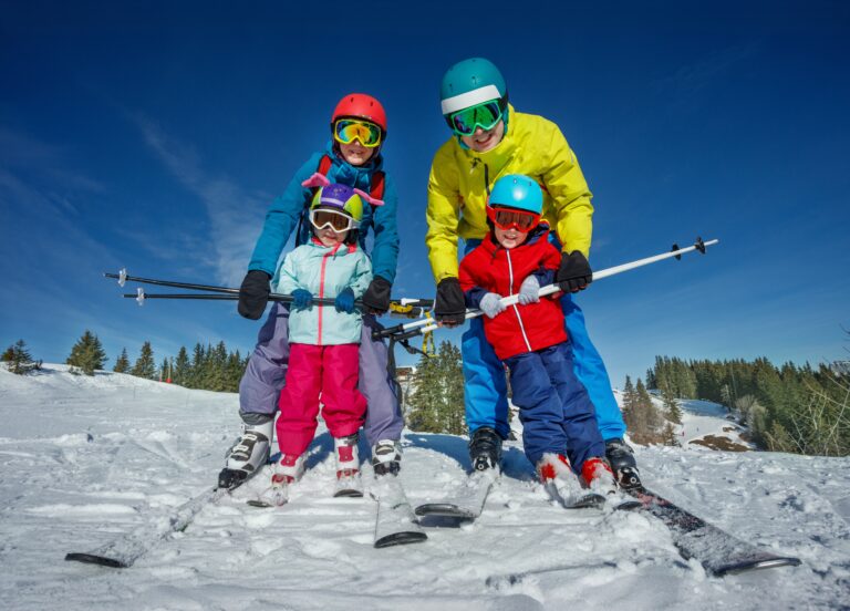 Parents,Teach,Kids,To,Ski,Hold,Between,Legs,Wearing,Bright