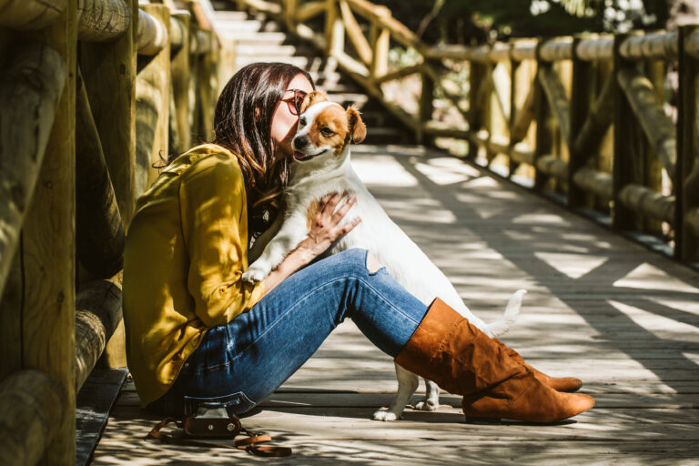 Young,Beautiful,Woman,Playing,With,Her,Sweet,Little,Dog,In