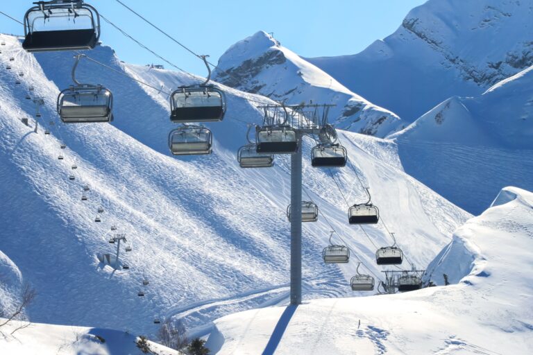 An,Empty,Chairlift,On,A,Background,Of,Snowy,Slopes,And