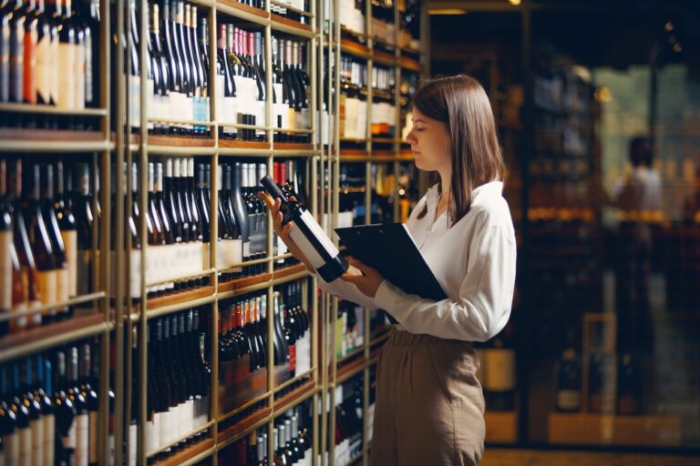 Professional,Female,Sommelier,Working,In,Winery,And,Making,Notes,On