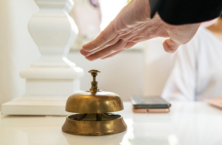 Close-up,Of,Hotel,Reception,Desk,Featuring,Antique,Brass,Service,Bell.