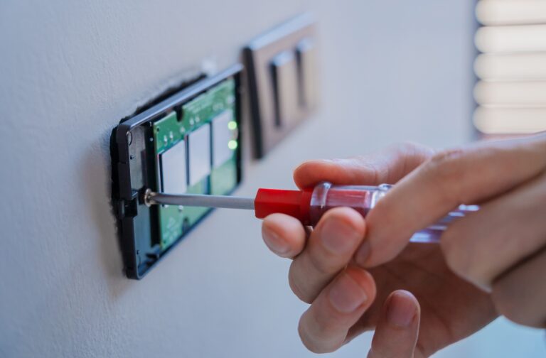 Technician,Installing,Sensor,Light,Switch,At,Modern,Villa