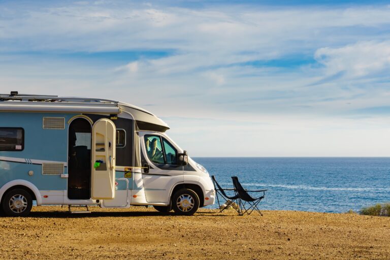 Caravan,With,Camp,Chairs,On,Mediterranean,Coast,,Spain.,Wild,Camping