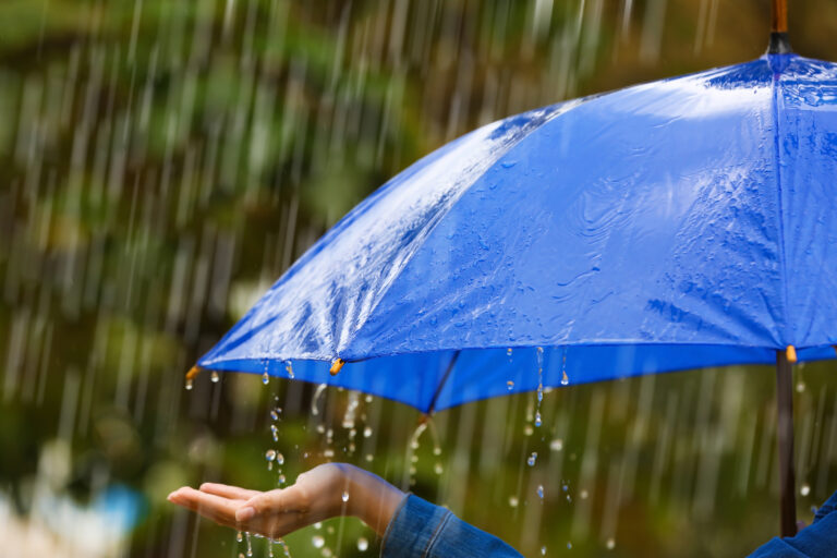 Woman,With,Bright,Umbrella,Under,Rain,On,Street,,Closeup