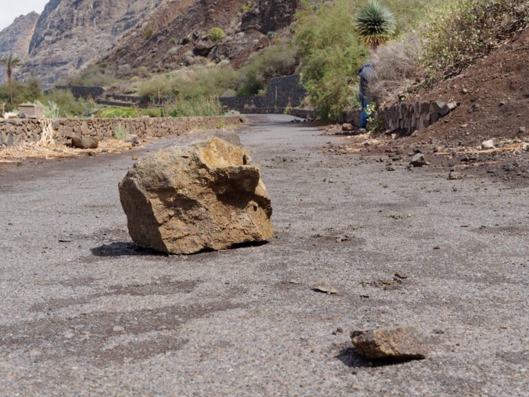 Large,Chunks,Of,Stone,Lying,On,A,Road,After,Heavy