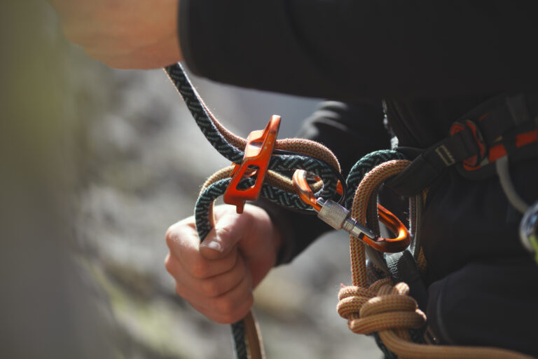 Easy,Belay-descender,Device,In,The,Hands,Of,A,Climber,Closeup.