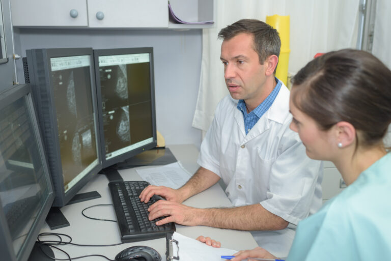 Doctors,Checking,Xray,On,A,Computers,Screen,On,A,Desk