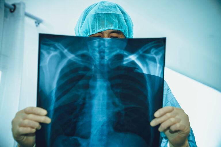 Surgeon,Looking,At,X-ray,Film.