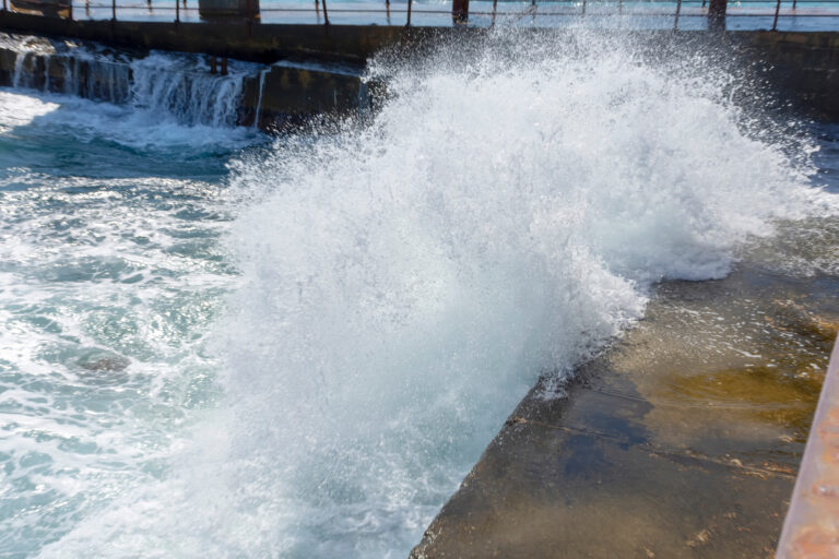 Splashing,From,Breaking,Waves,On,The,Pier