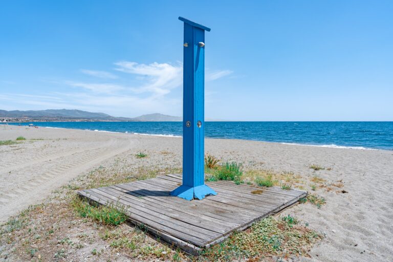 Traditional,Old,Blue,Wooden,Shower,On,The,Sand,Of,The