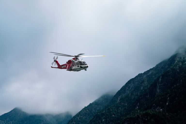 Rescue,Helicopter,In,Flight,Between,Clouds,And,Mountains
