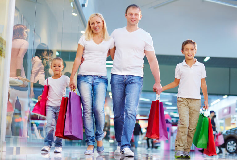 Portrait,Of,Modern,Family,With,Paperbags,Walking,In,The,Mall