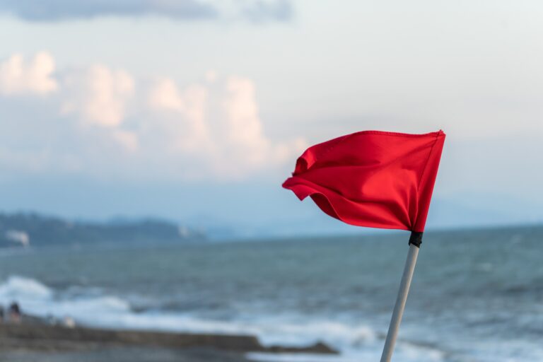 Red,Flag,By,The,Sea,In,The,Evening