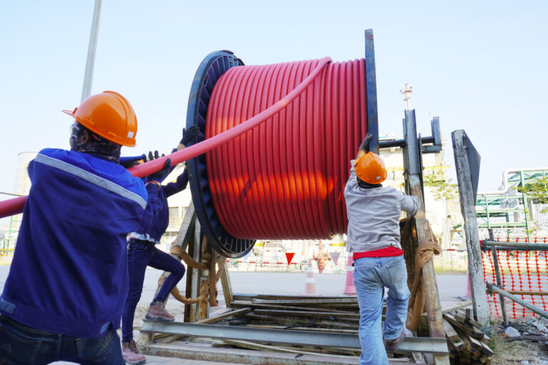 Workers,Pulling,High,Voltage,Cable,Line,Or,Large,Electric,Cable
