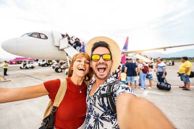 Happy,Couple,Of,Tourists,Boarding,On,A,Plane,At,The