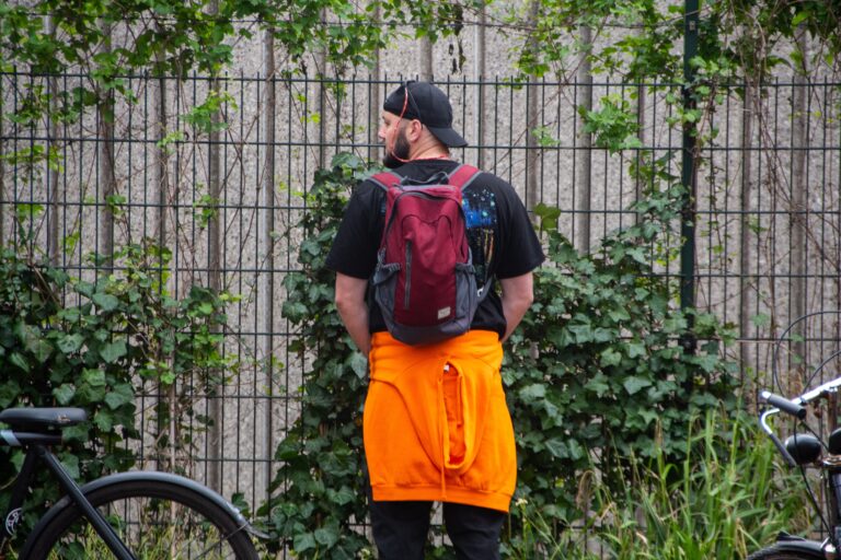 A,Man,Standing,Peeing,In,A,Park