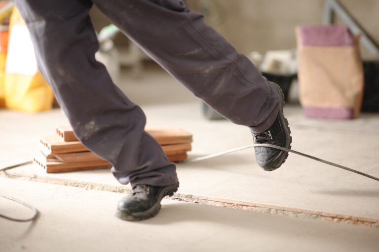 Close,Up,Of,A,Construction,Worker,Stumbling,With,A,Cord