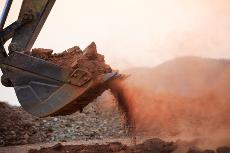 Excavator,Working,With,Red,Soil,And,Dusty