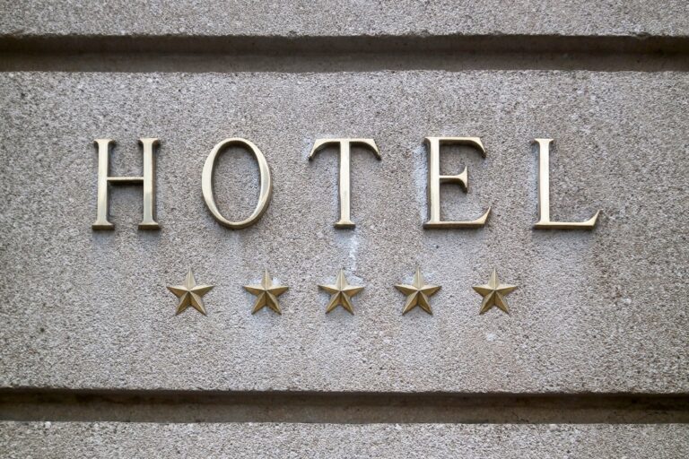 Close-up,On,A,Brass,5,Stars,Hotel,Sign.