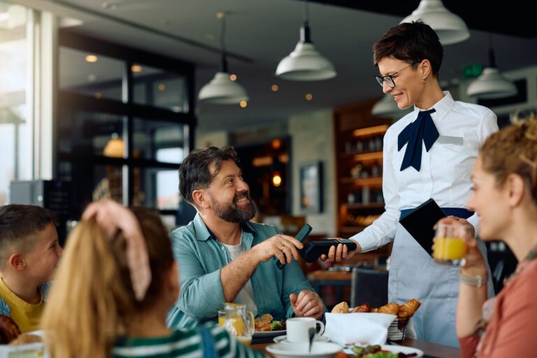 Happy,Father,Paying,Contactless,With,Mobile,Phone,While,Having,Breakfast