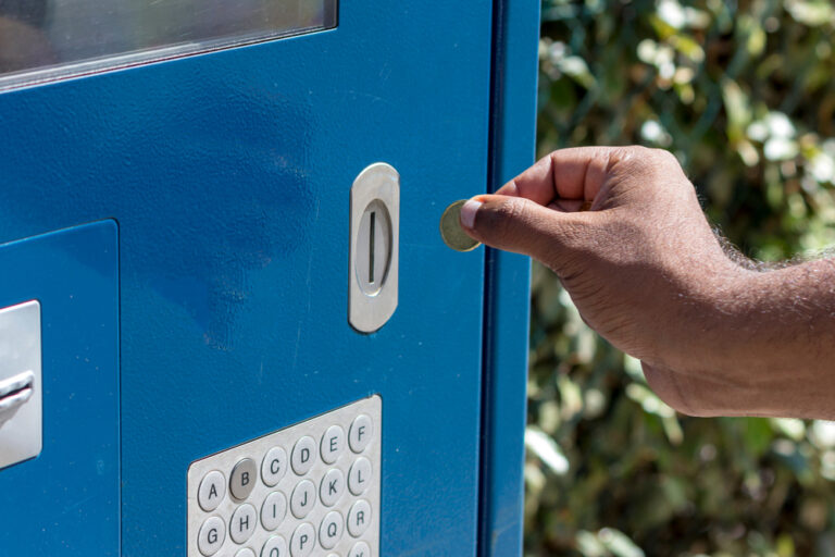 Hand,Puts,A,Coin,Into,The,Parking,Machine