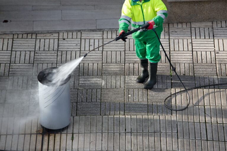 Sweeper,Cleaning,A,Trash,Can,On,Sidewalk,With,High,Pressure
